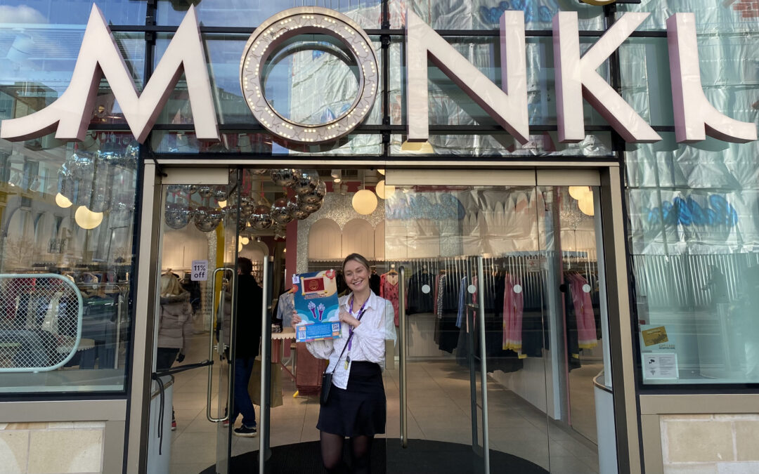 Meagan Hall, store manager of Monki, holding the Lunar New Year Trail poster