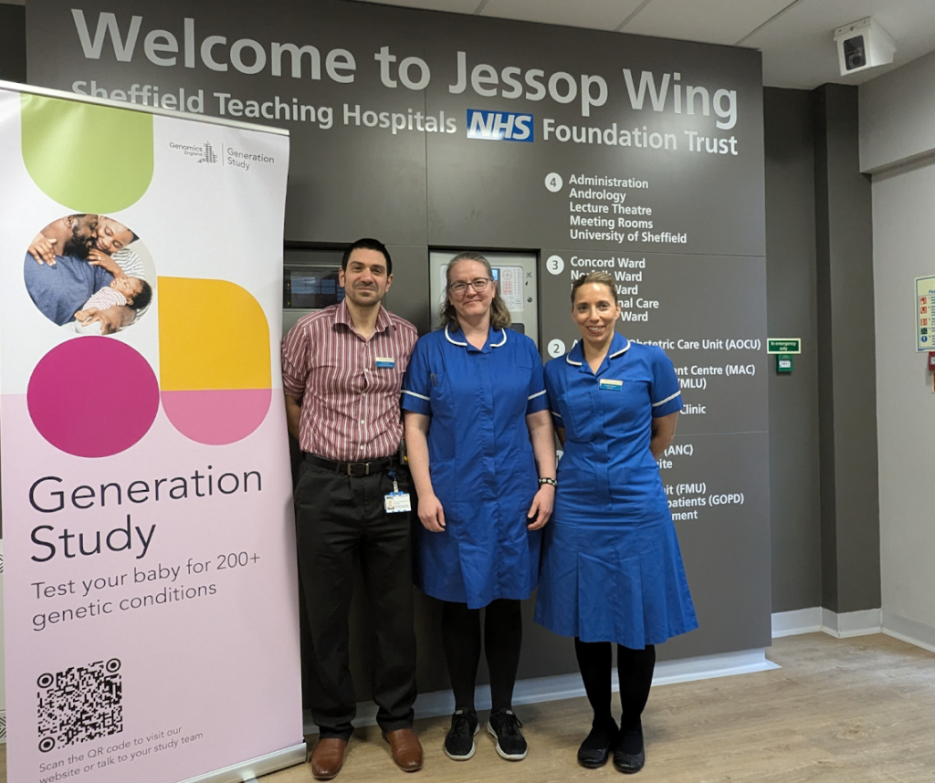 The Jessop Wing team smiling beneath a sign that says 'Welcome to Jessop Wing.' They are stood next to a sign which reads 'Generation Study, test your baby for two-hundred plus genetic conditions.'