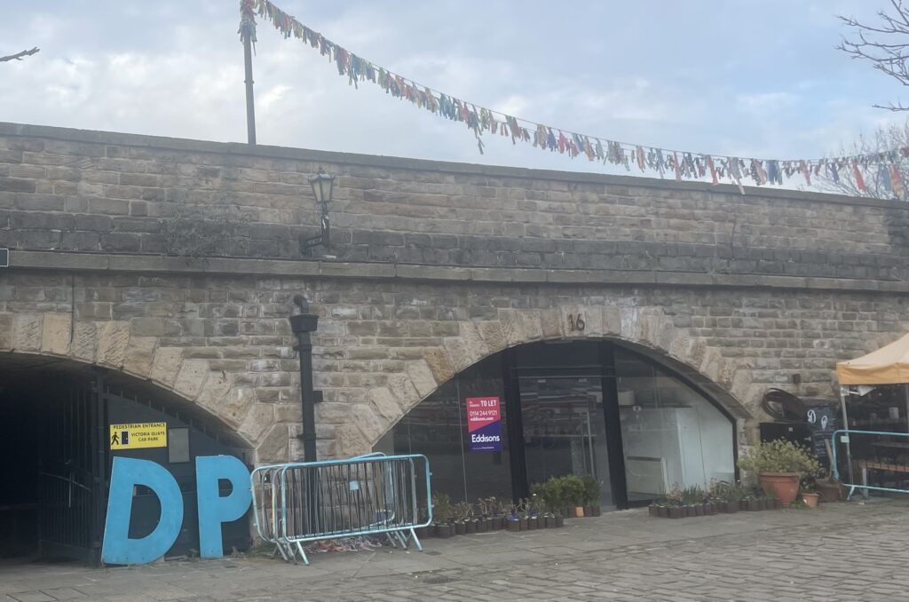 The sign for the music venue sat outside an arch, underneath the bridge