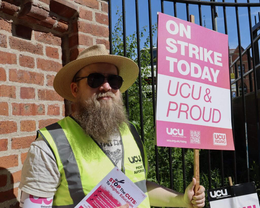 David Hayes at the Strike on Wednesday holding a sign saying on strike today. UCU and proud 