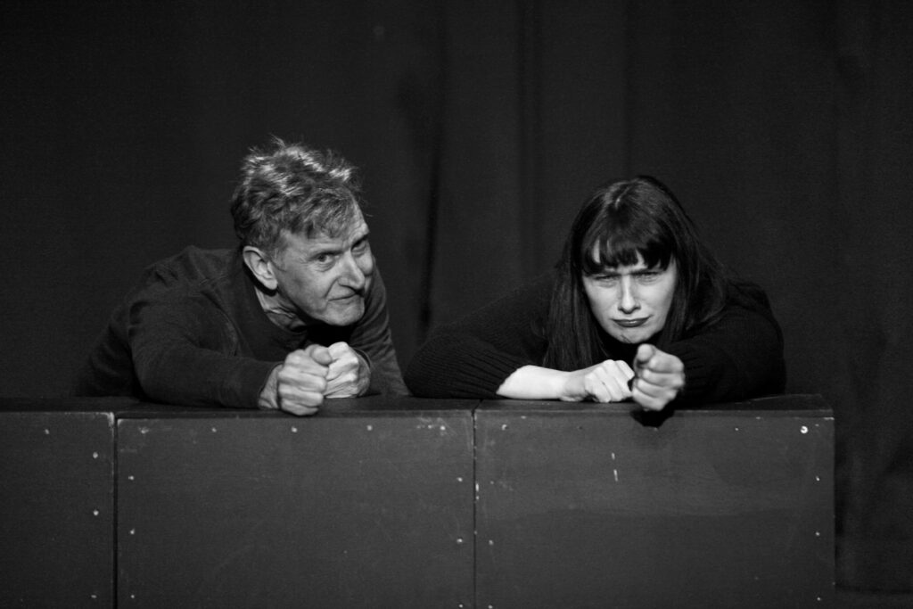 Actors performing on stage.