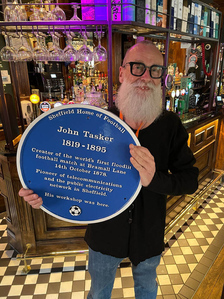 The Blue Plaque held up at the Frog and Parrot Pub. 