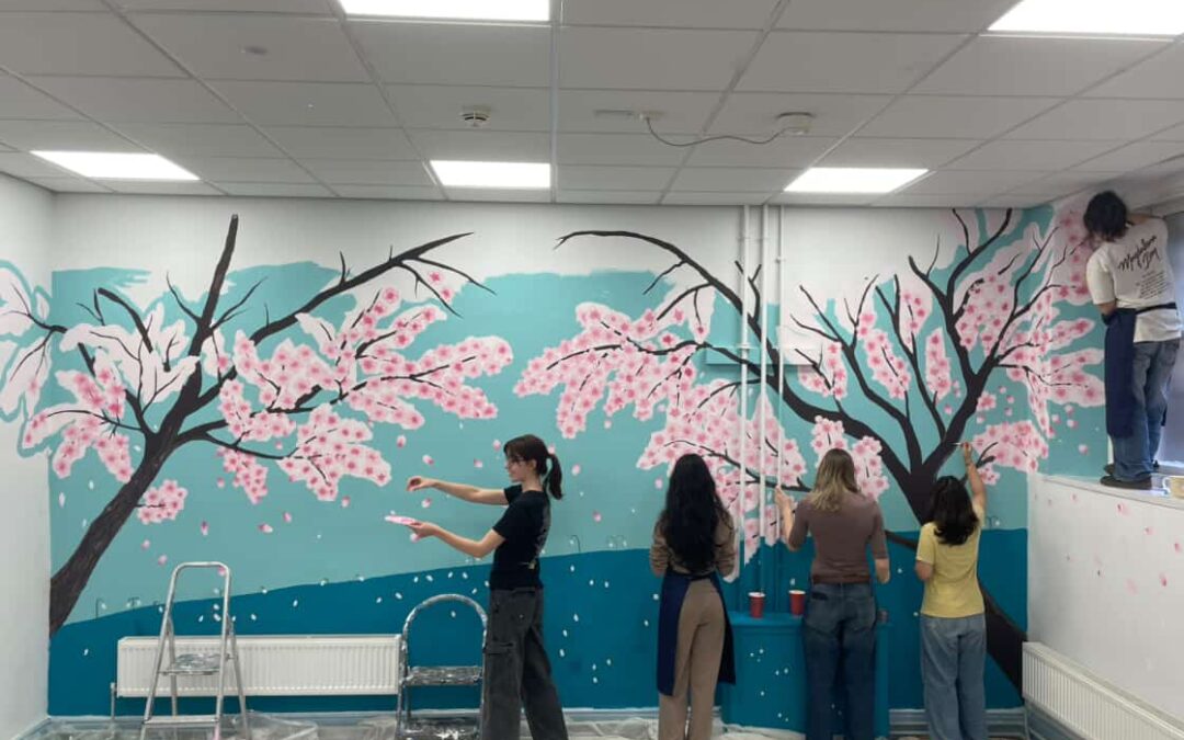 A group of people painting a flowery mural