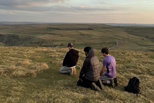 Three students praying 'Maghrib Salah' before twilight.