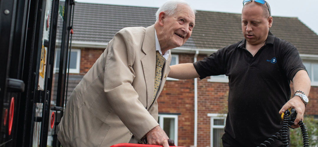 An elderly man being helped by community transport