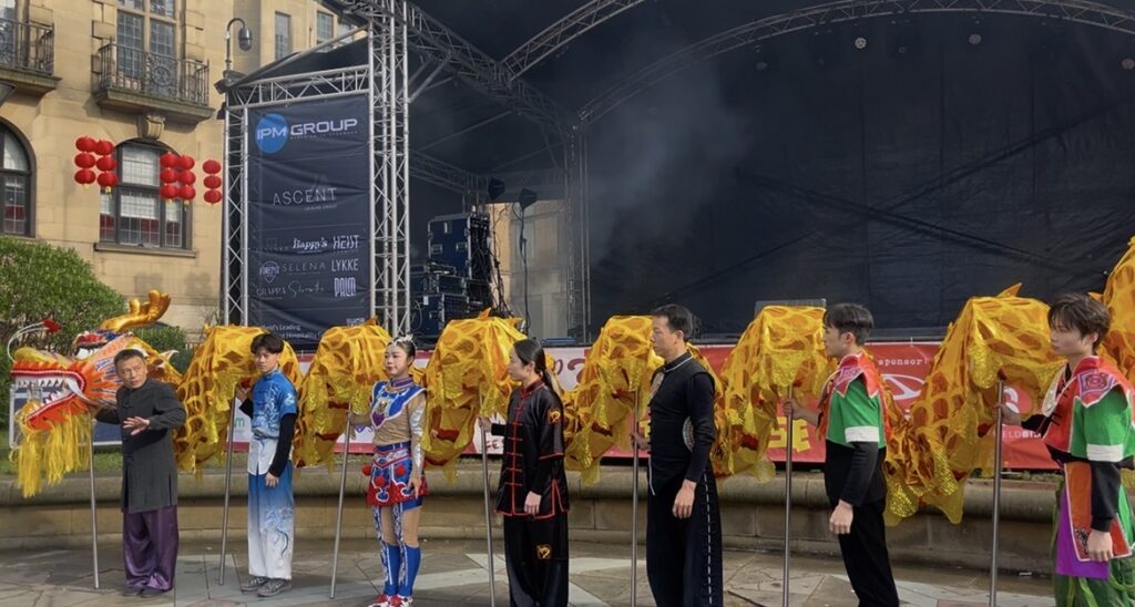 Dragon dancers in line