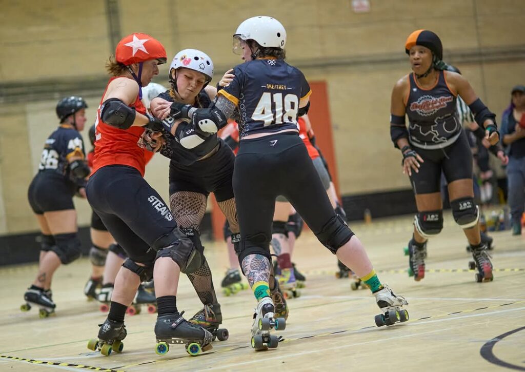 Women playing roller derby in a sports hall