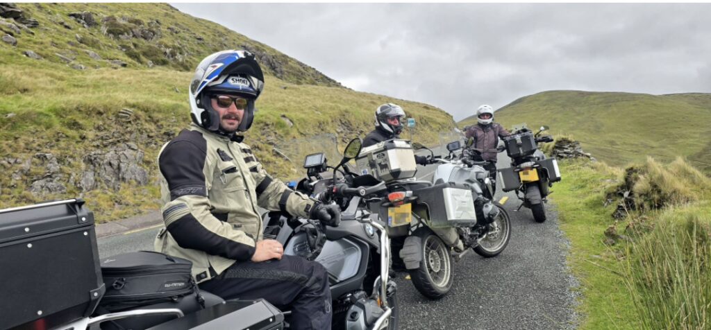 Three motorcyclists in a valley staring at the camera