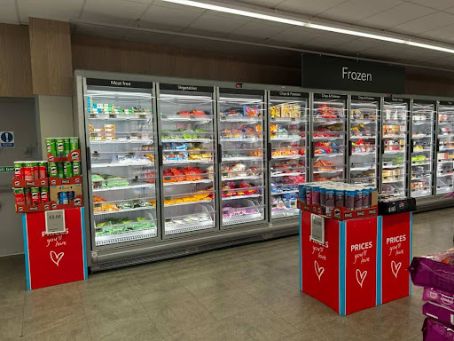 Supermarket fridges stocked with food in the co-op store.