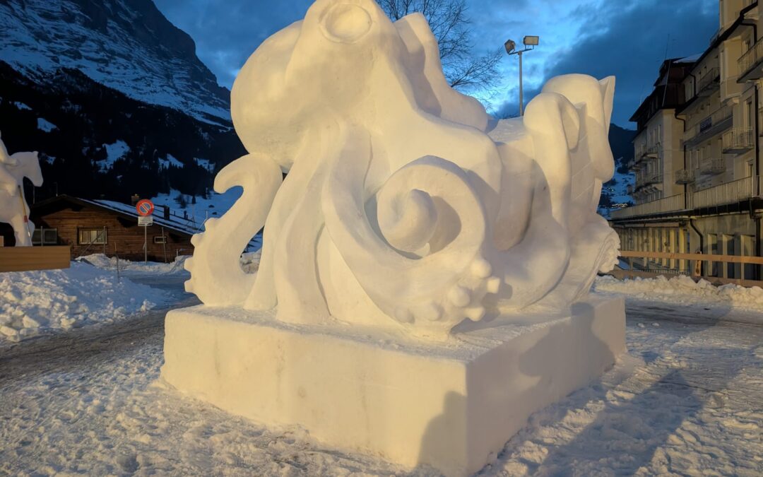 Snow sculpture of kraken eating ship made by the team