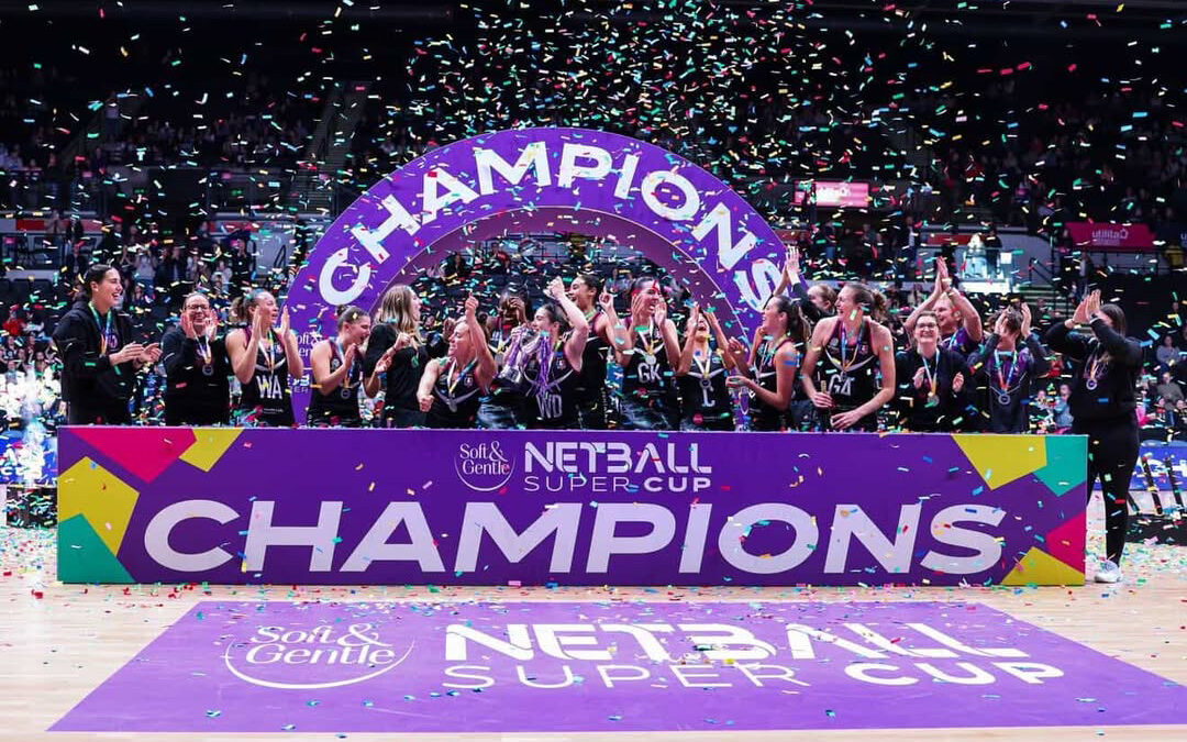 netball team with champions sign and confetti