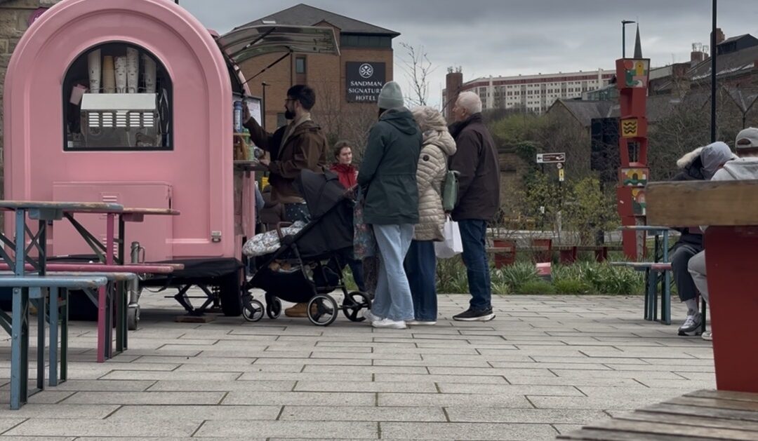people queuing at a van for food
