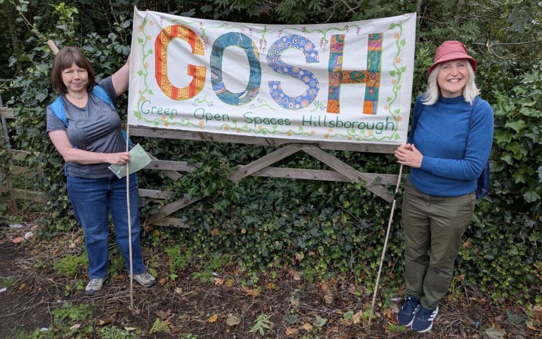 picture of two ladies holding up a sign that says GOSH