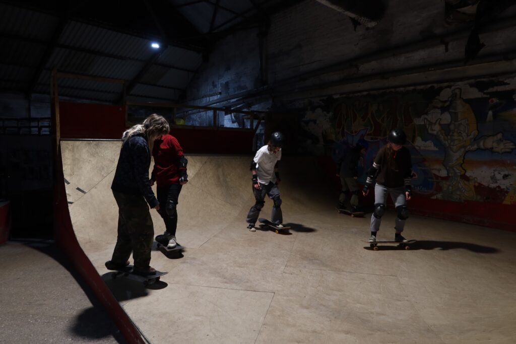 Fern Jeferzade teaching New Wave skaters how to skateboard on the House half-pipe.