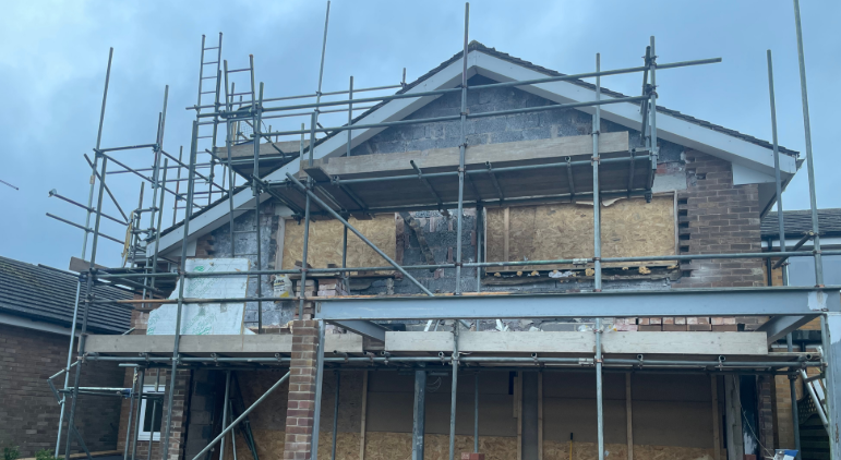 A house covered in scaffolding and building material