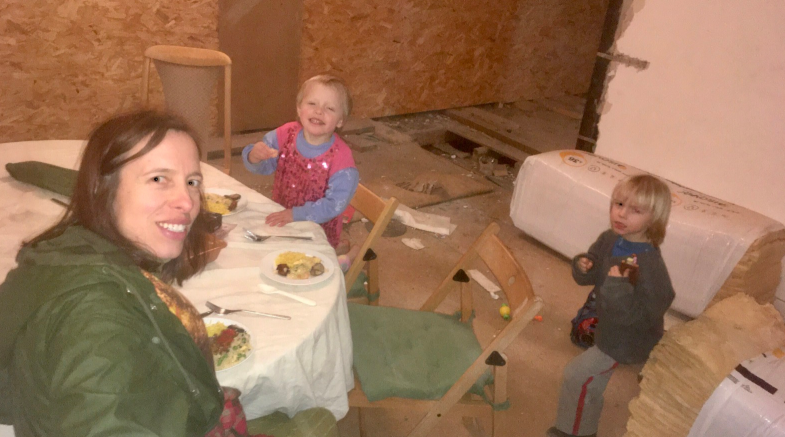 Mrs Nygaard and her two children having dinner inside the building site. She is taking a selfie