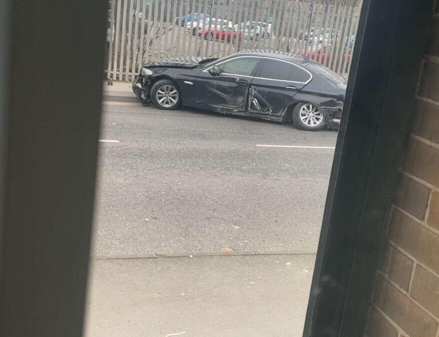 damaged car left at the side of a road