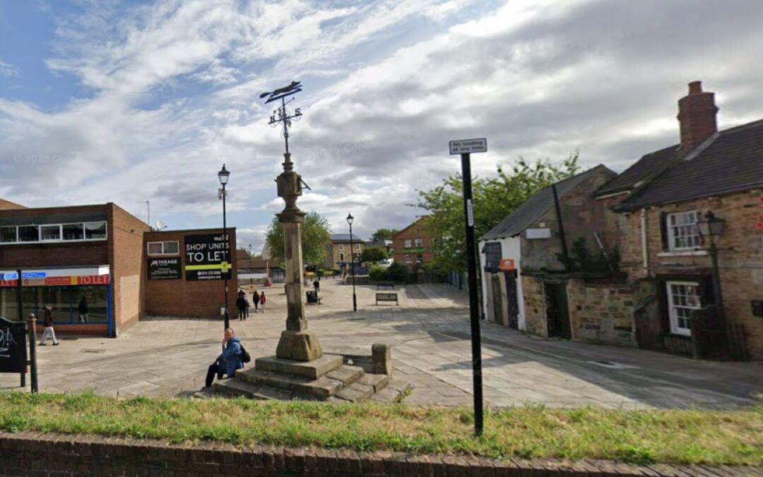 A town square with shops and a pillar