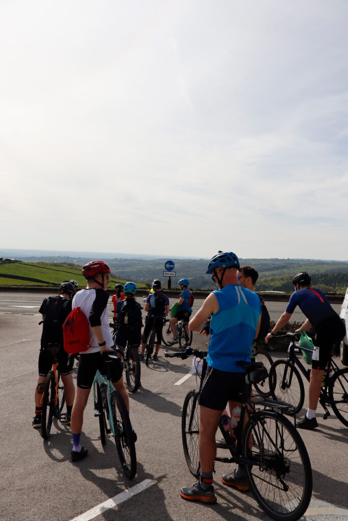 A group of athletes waiting at their bikes.