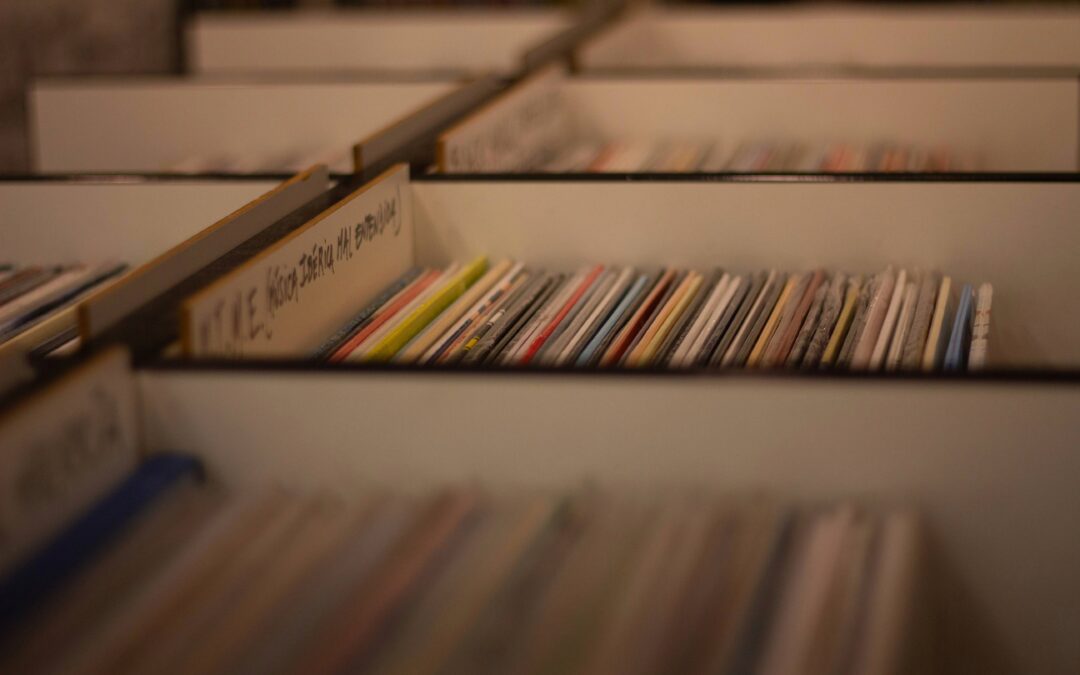 A large selection of record vinyls stacked against one another.