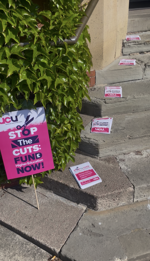 posters outside a hall and on steps