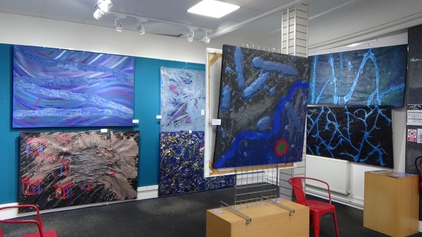 Mulitple hung up images of the Exhibiton put on by Steve Montogmery.
Dark and light blues mixed with cracking 
