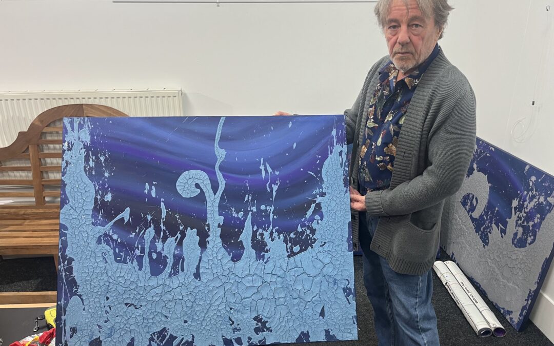 Steve Montgomery standing in front of his artwork.