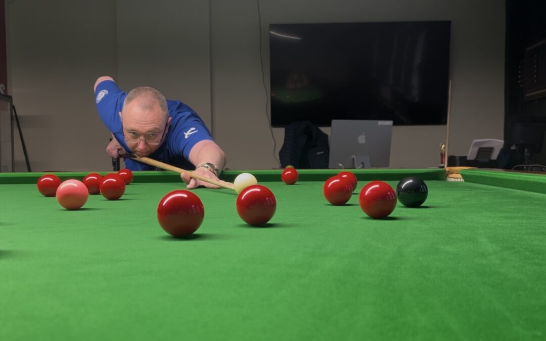 A man playing snooker