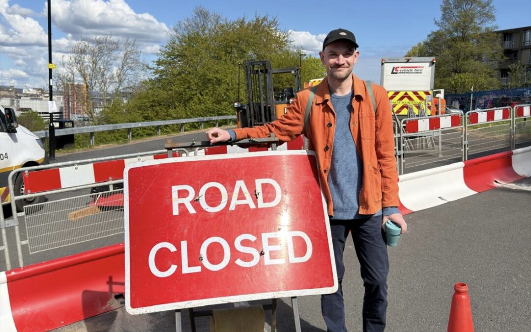 Man standing next to 'road closed' sign in Parkhill Sheffield