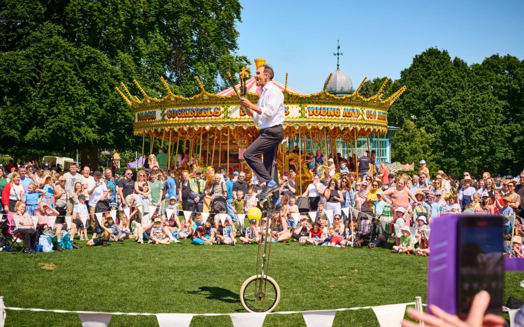 Man on a tricycle, surrounded by a large crowd of people