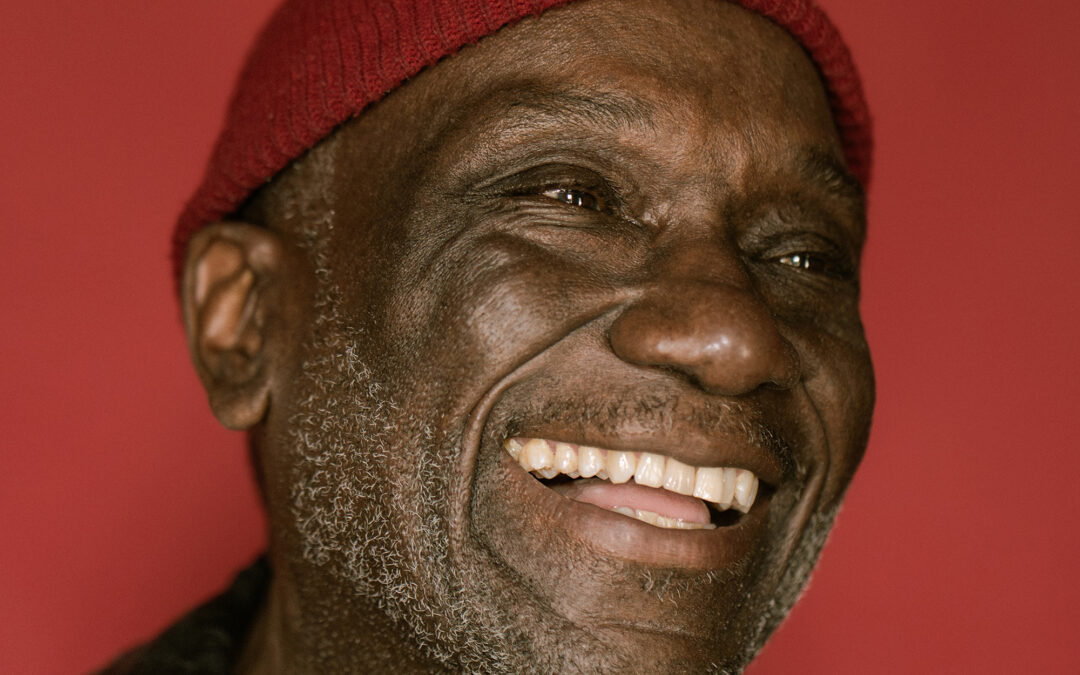 A man looking away from the camera smiling